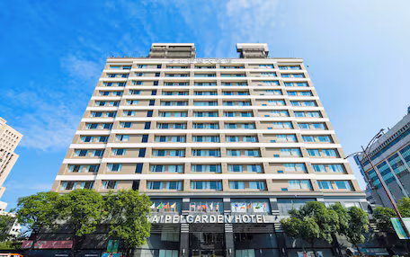 A multi-story hotel with a modern design, featuring a prominent sign at the entrance.