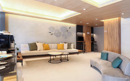 A modern living room with a sofa, coffee table, and a TV.