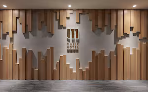 A wall with a geometric pattern of wooden panels and a sign that reads "MUSIC HOTEL."