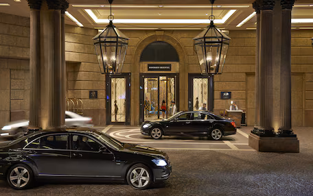 A lobby with a grand entrance, large columns, and a sign for 'Mandarin Oriental'.